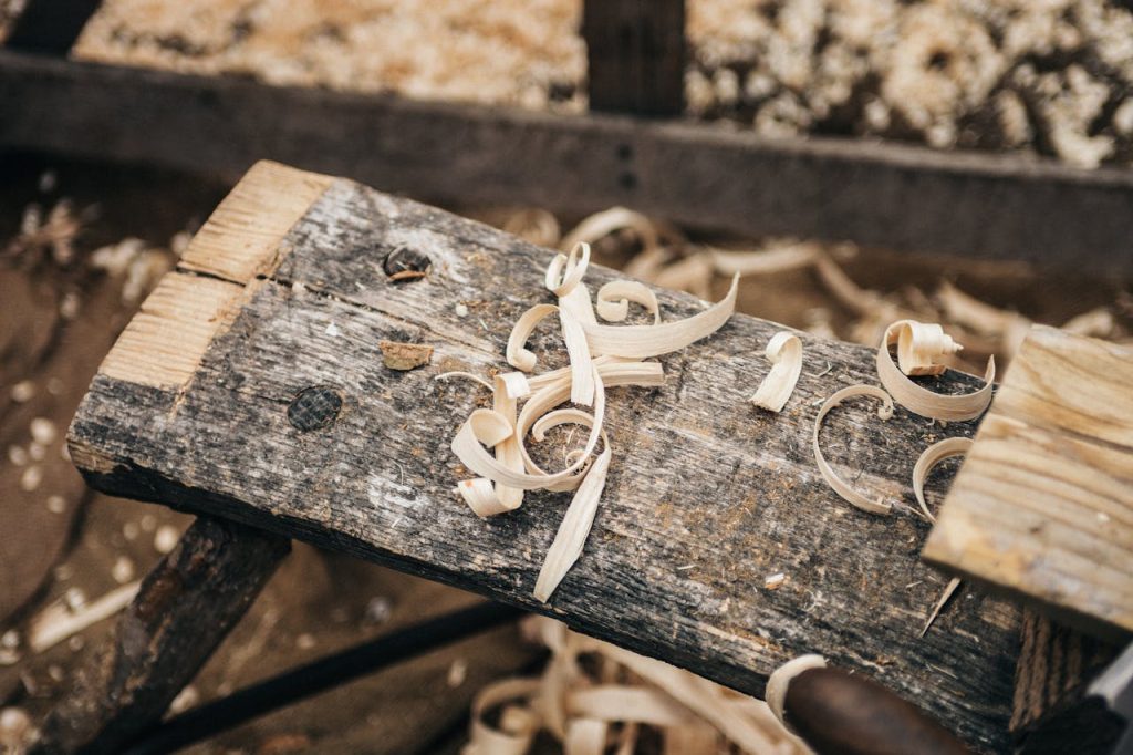 Mastering the First Impression: Your intriguing post title goes here Rustic workbench covered in wood shavings, showcasing detailed craftsmanship.